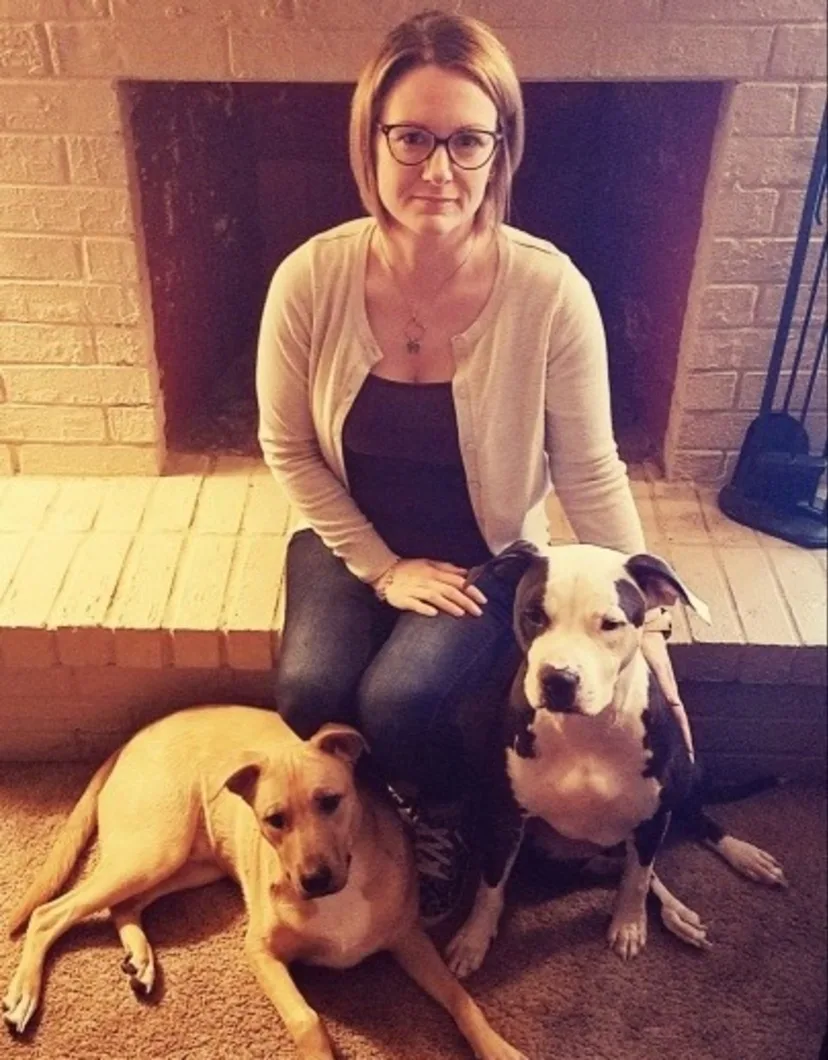 Jennifer Hawn, Hospital Manager at North Channel Animal Hospital, sitting with two dogs